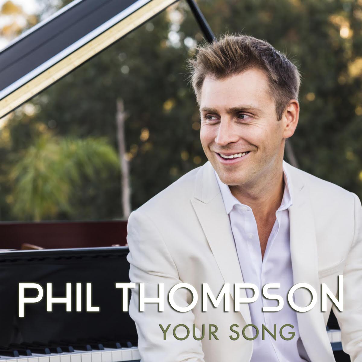 Phil Thompson sitting at Grand Piano performing Elton John's "Your Song"